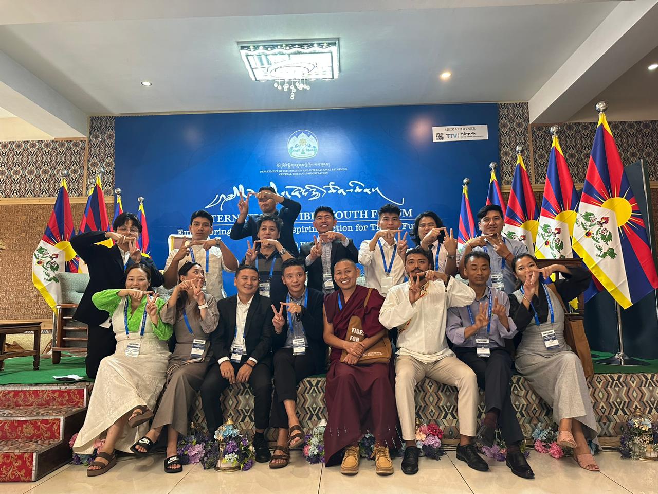 A group picture of V-TAG India members at International Tibetan Youth Forum posing with the V-TAG sign.